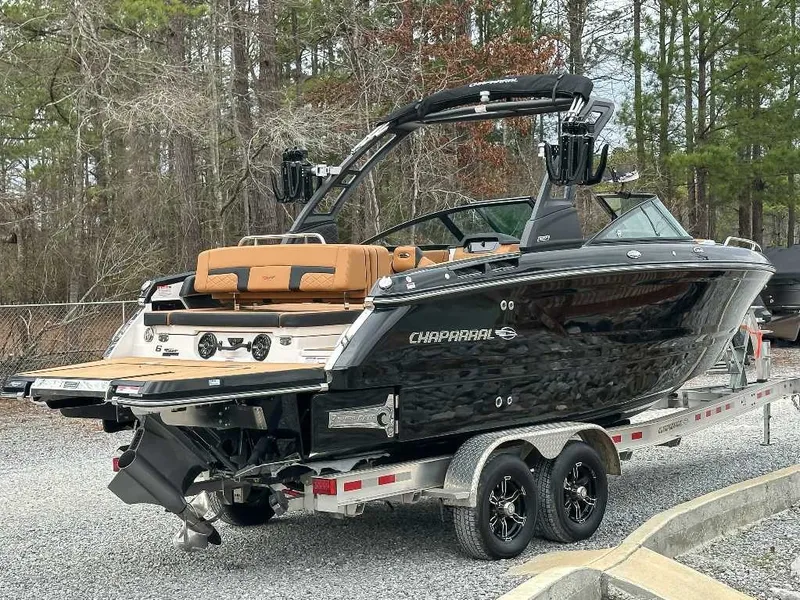 Slide: The Image of 2026 Chaparral GTS 6 on a trailer, featuring a black hull and brown seating. - 7