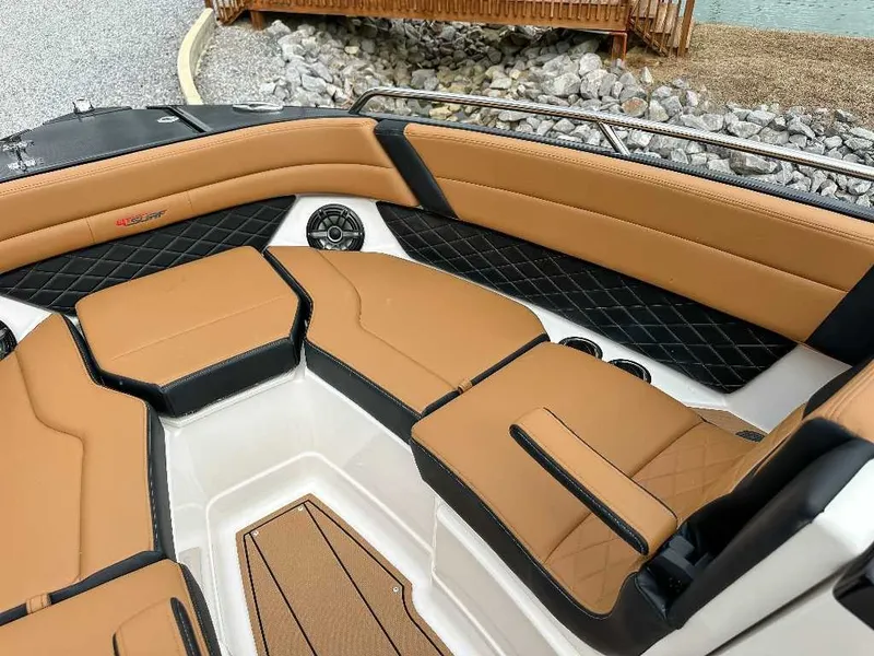 Slide: The Image of The image shows the interior of a Chaparral GTS 6 boat with sleek, brown upholstery. - 18