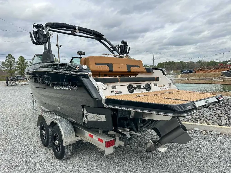 Slide: The Image of The image shows a 2026 Chaparral GTS 6 boat on a trailer, featuring a sleek black hull and spacious swim platform. - 9