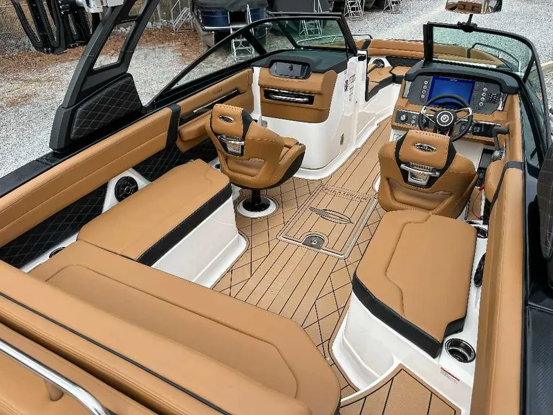Slide: The Image of Interior of a 2026 Chaparral GTS 6 with luxurious brown seating and a modern dashboard. - 14
