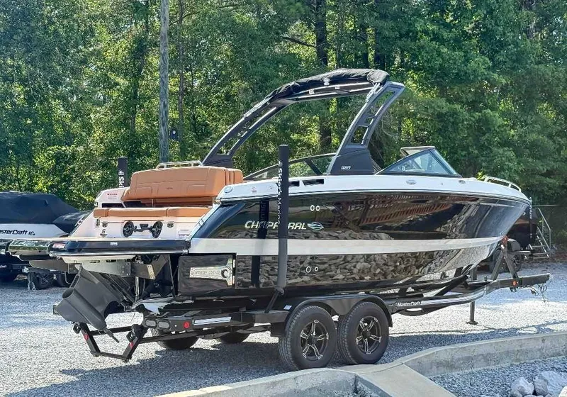 Slide: The Image of 2026 Chaparral GTS 6 on a trailer, glossy black with white accents, parked outdoors. - 7