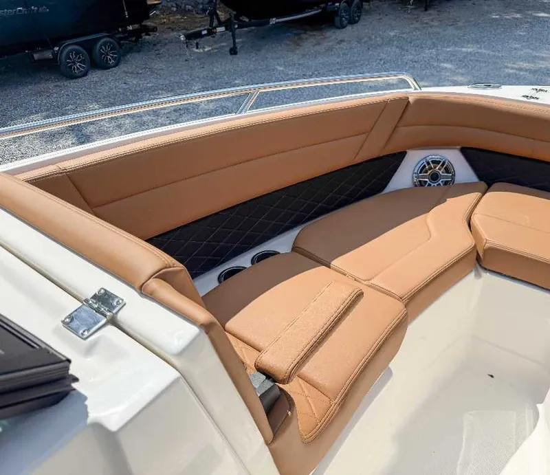 Slide: The Image of The image shows the bow area of a Chaparral GTS 6 with beige upholstery and speakers. - 10