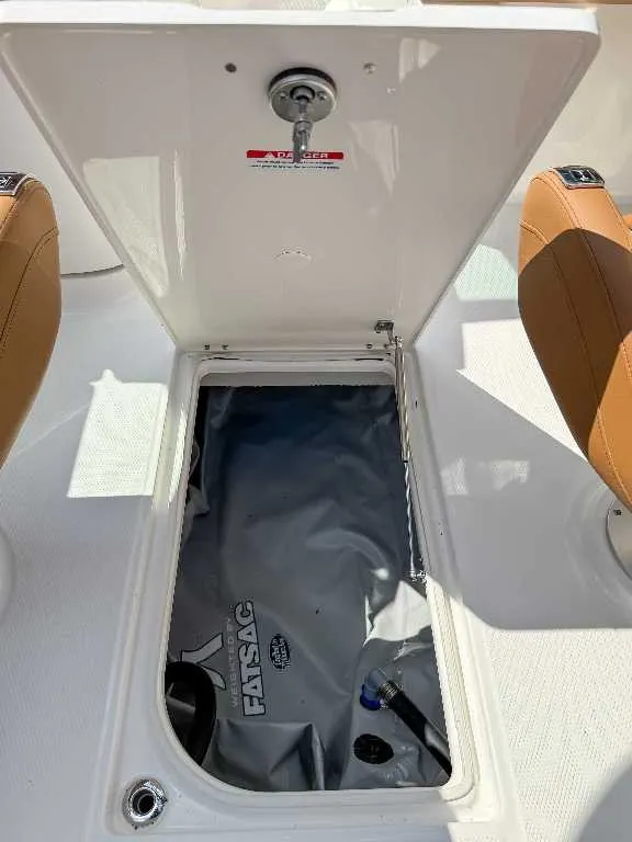 Slide: The Image of An open storage compartment on a boat with a Fatsac water bag inside. - 18