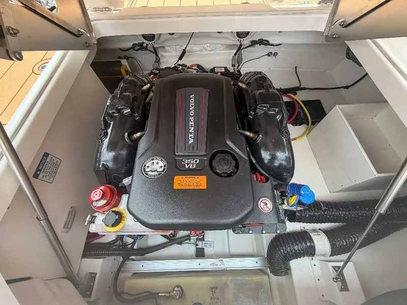 Slide: The Image of A powerful engine in a well-organized boat engine compartment, surrounded by hoses and cables. - 25