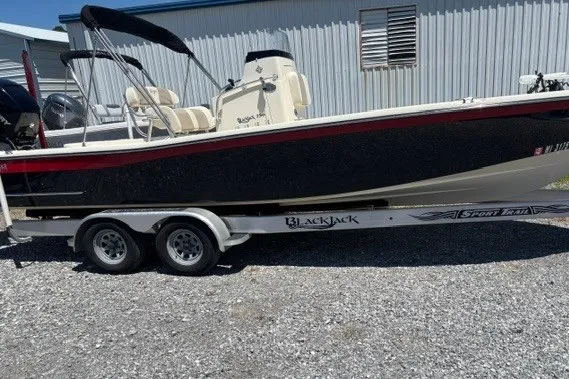 The Image of 2016 K2 Marine Blackjack 256 boat on trailer, parked outdoors. - 2