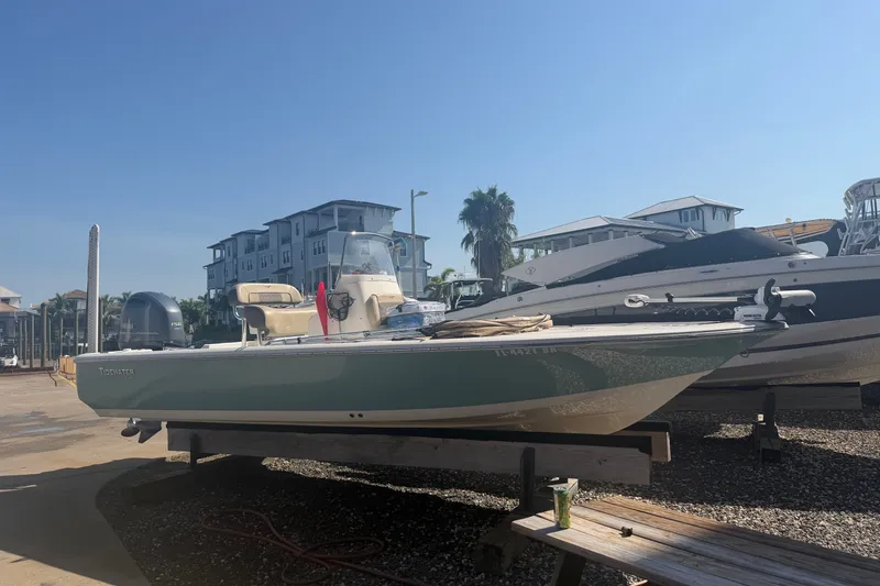 The Image of 2019 Tidewater 2110 Bay Max Tunnel boat on display at a marina. - 5