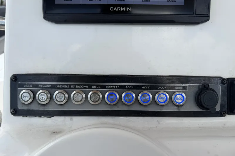 Slide: The Image of Control panel of a 2020 Tidewater 2110 Bay Max boat with labeled switches. - 18