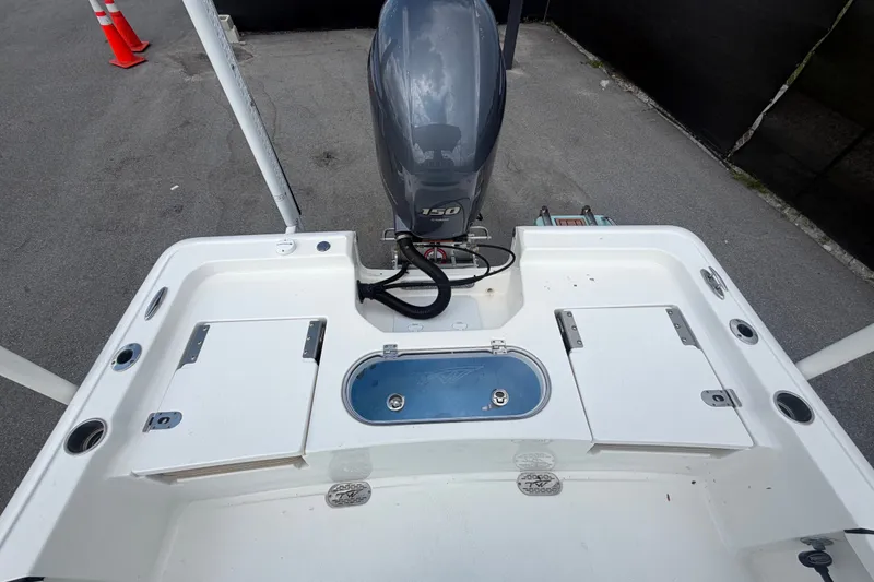 Slide: The Image of 2020 Tidewater 2110 Bay Max boat with outboard motor and storage compartments. - 49