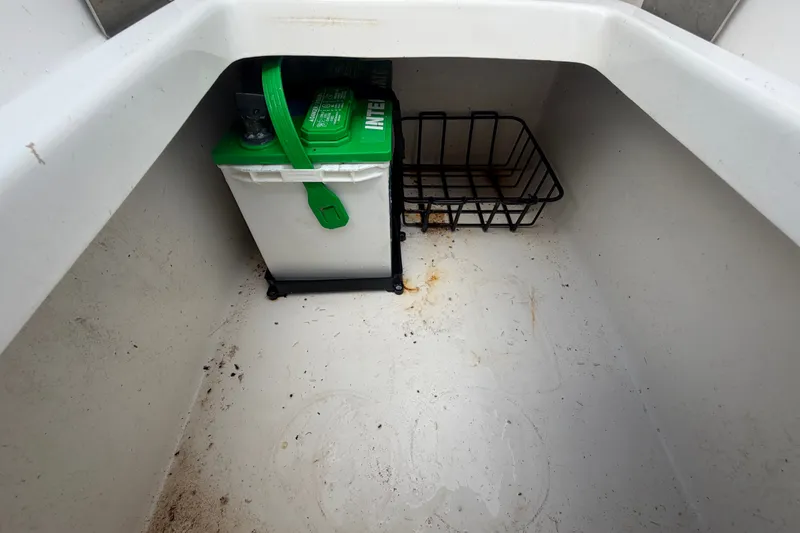 Slide: The Image of Battery compartment of 2020 Tidewater 2110 Bay Max boat with storage basket. - 57