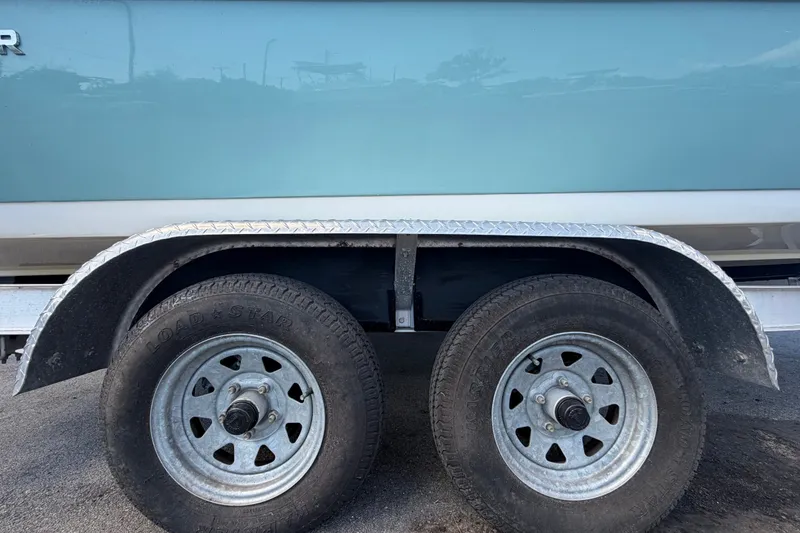 Slide: The Image of Trailer wheels of a 2020 Tidewater 2110 Bay Max boat on pavement. - 66