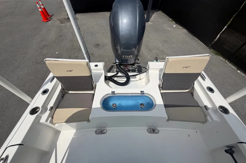 Slide: The Image of 2020 Tidewater 2110 Bay Max boat interior with seating and motor. - 48