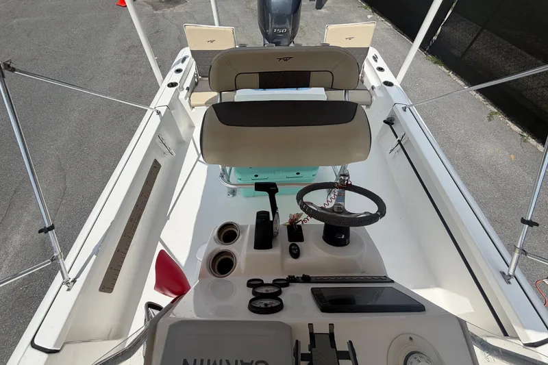 Slide: The Image of The image shows the cockpit of a 2020 Tidewater 2110 Bay Max boat with a helm console and seating. - 46