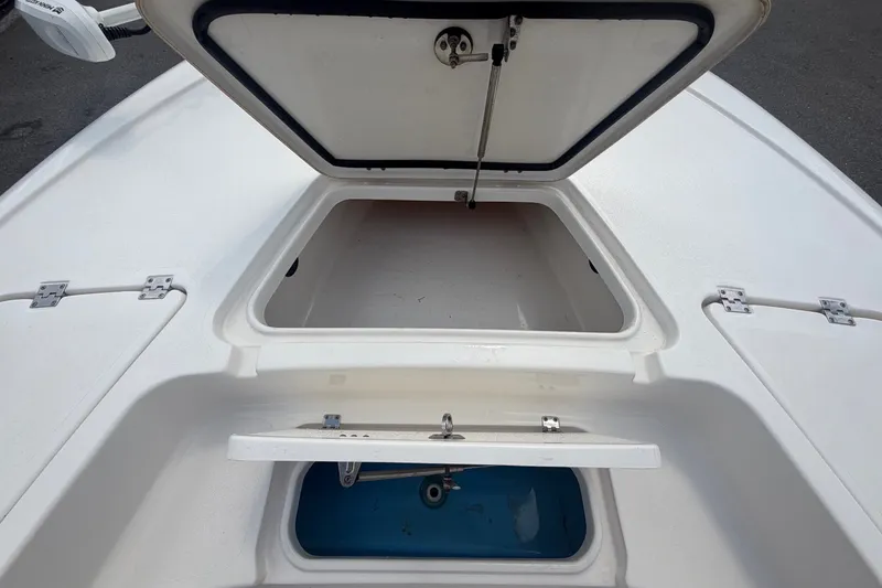Slide: The Image of The image shows the storage compartment and fish box of a 2020 Tidewater 2110 Bay Max boat. - 31