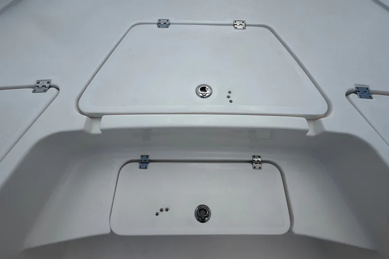 Slide: The Image of 2020 Tidewater 2110 Bay Max boat storage compartments with secure latches. - 30