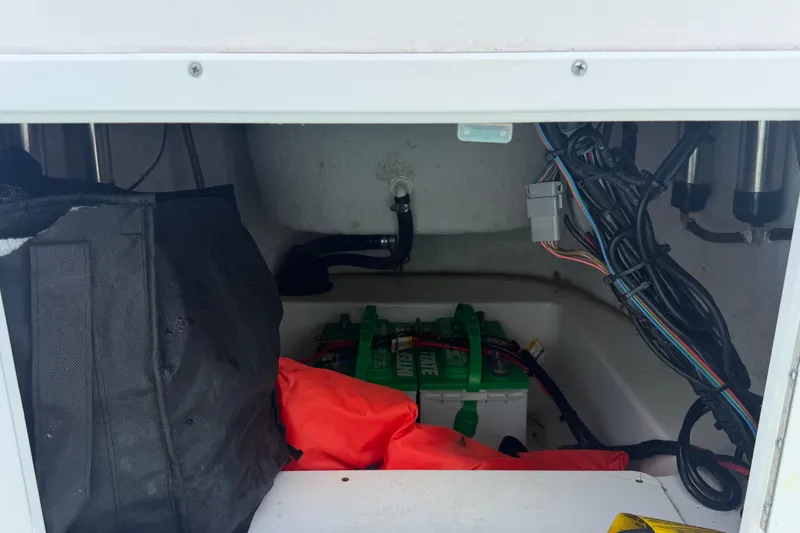 Slide: The Image of Storage compartment of 2020 Tidewater 2110 Bay Max boat with battery and wiring. - 24
