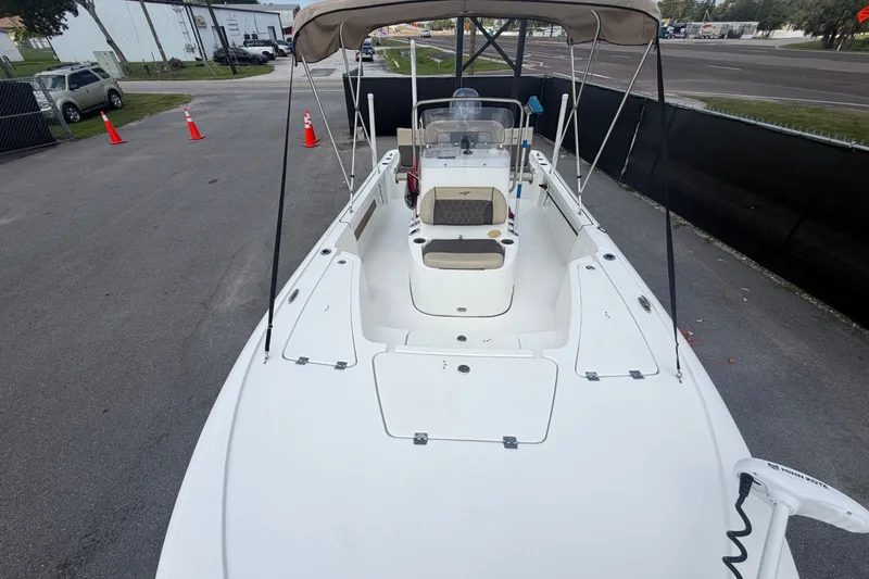 Slide: The Image of 2020 Tidewater 2110 Bay Max boat with canopy, parked on pavement near traffic cones. - 40
