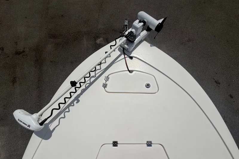 Slide: The Image of The image shows the bow deck of a Tidewater 2110 Bay Max boat with a mounted trolling motor. - 34