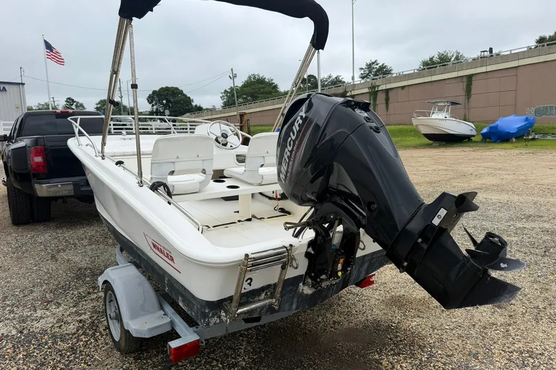 Slide: The Image of 2017 Boston Whaler 130 Super Sport boat on trailer with Mercury outboard motor. - 8