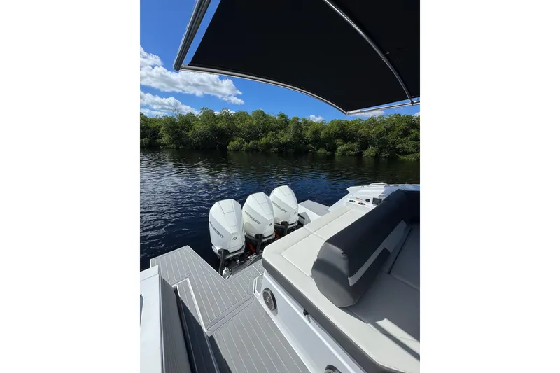 Slide: The Image of 2022 Cruisers Yachts 38 GLS OB on water, featuring triple outboard engines. - 25