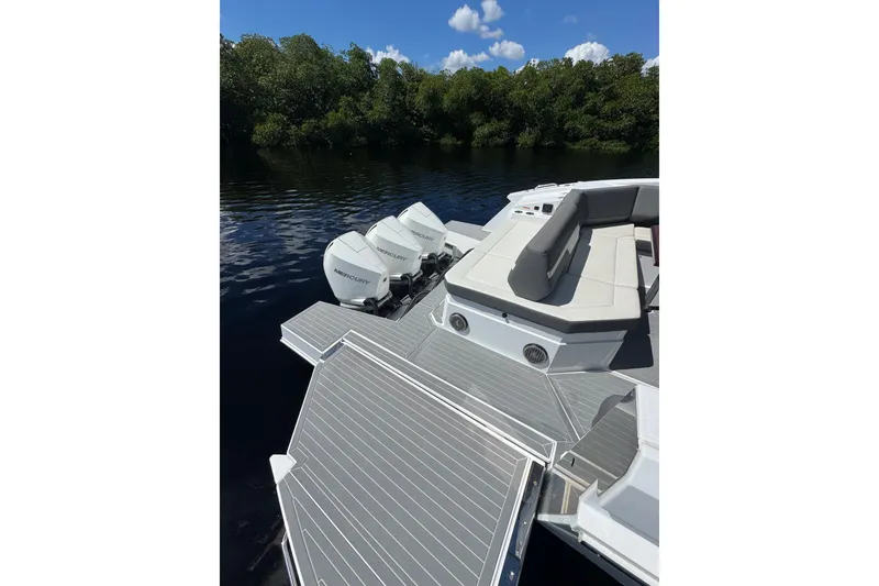 Slide: The Image of 2022 Cruisers Yachts 38 GLS OB with Mercury outboards on a serene waterway. - 8