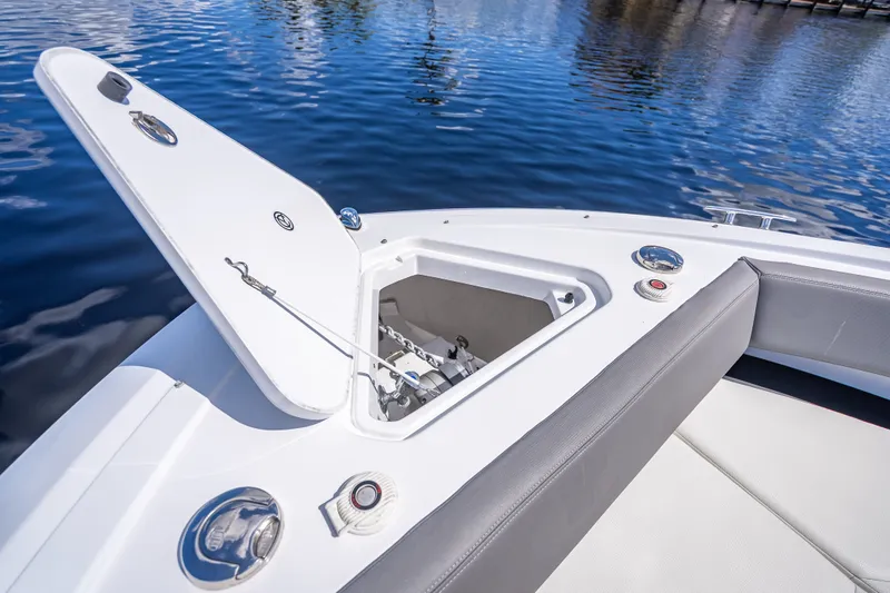 Slide: The Image of 2022 Cruisers Yachts 38 GLS OB bow with open anchor compartment on water. - 10
