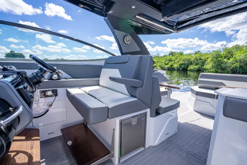 Slide: The Image of 2022 Cruisers Yachts 38 GLS OB interior with sleek seating and modern controls. - 23