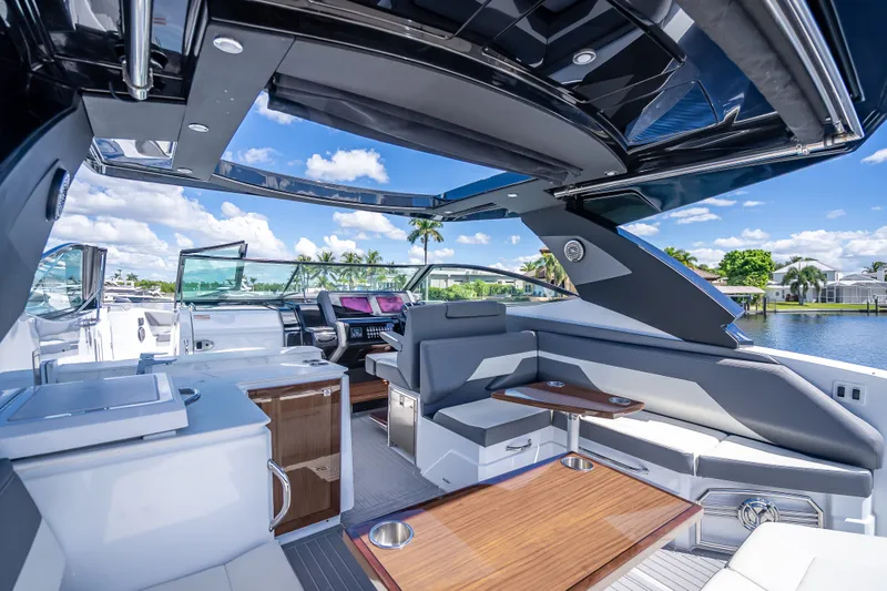 Slide: The Image of 2022 Cruisers Yachts 38 GLS OB interior with luxurious seating and modern amenities. - 32