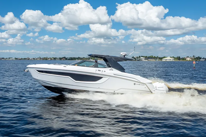 Slide: The Image of 2022 Cruisers Yachts 38 GLS OB speeding on water under a blue sky. - 5