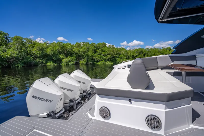 Slide: The Image of 2022 Cruisers Yachts 38 GLS OB with Mercury engines on a serene waterway. - 29