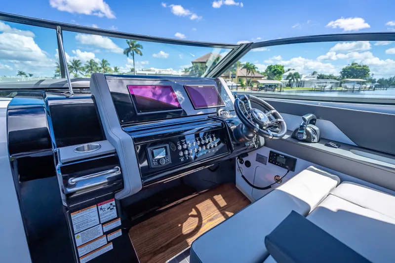 Slide: The Image of 2022 Cruisers Yachts 38 GLS OB helm with modern controls and dual screens. - 18