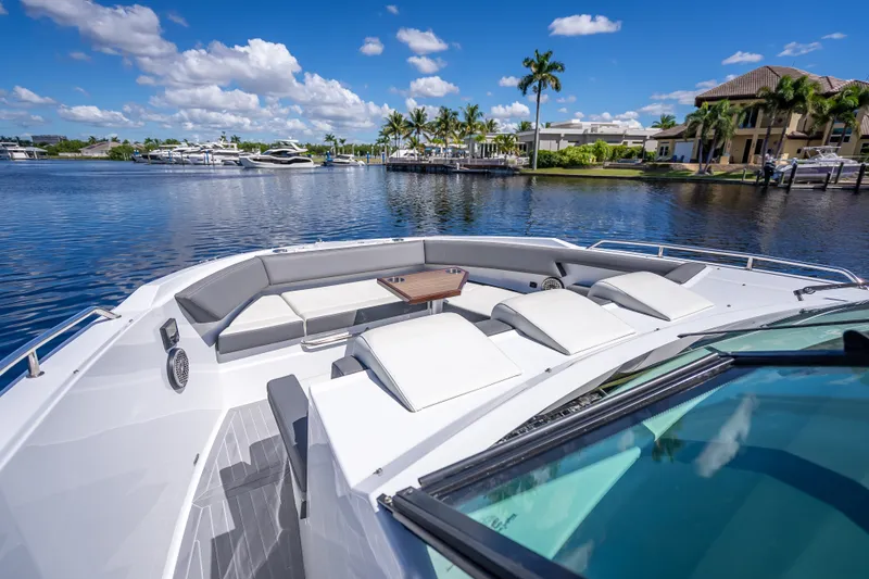 Slide: The Image of 2022 Cruisers Yachts 38 GLS OB on serene waterfront with luxurious seating. - 13