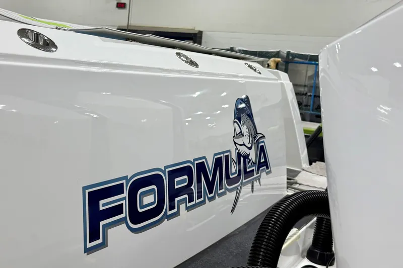 Slide: The Image of 2026 Formula 387 Center Console Fish boat with logo in a showroom setting. - 5