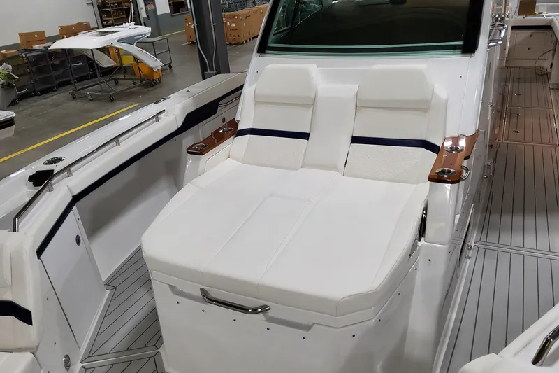 Slide: The Image of 2026 Formula 387 Center Console Fish boat interior with white seating and sleek design. - 16