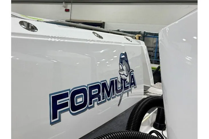 Slide: The Image of 2026 Formula 387 Center Console Fish boat with logo in a showroom. - 11