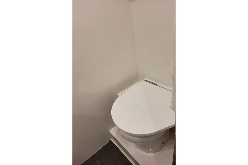 Slide: The Image of Interior view of 2026 Formula 387 Center Console Fish boat's compact bathroom. - 24