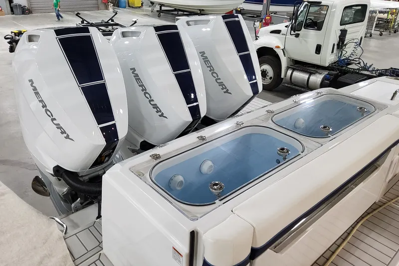 Slide: The Image of 2026 Formula 387 Center Console Fish with four Mercury outboard engines in a workshop. - 26