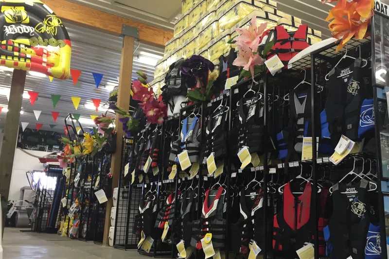 Slide: The Image of Store interior with colorful life jackets and boating accessories on display. - 13
