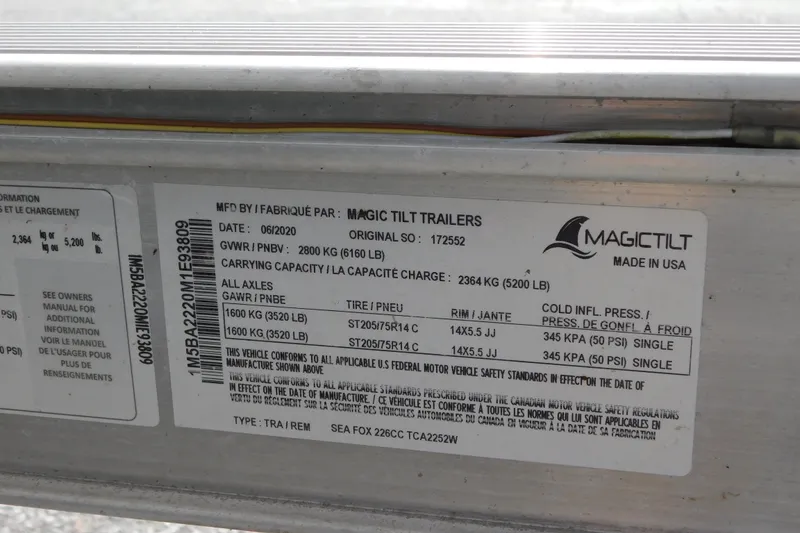 Slide: The Image of Magic Tilt trailer label for Sea Fox 228 Commander, 2021 model, showing specifications and capacities. - 28