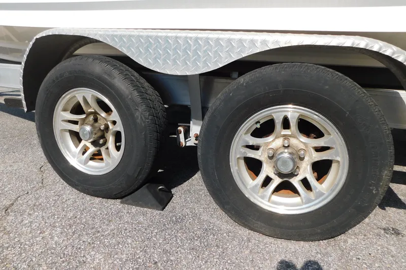 Slide: The Image of Trailer wheels of a 2021 Sea Fox 228 Commander boat on pavement. - 25
