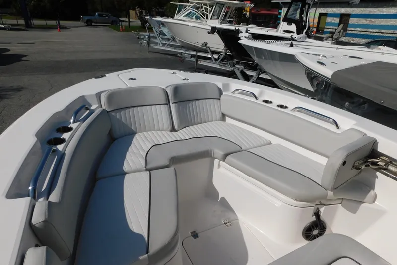 Slide: The Image of 2021 Sea Fox 228 Commander boat interior with cushioned seating and cup holders. - 5