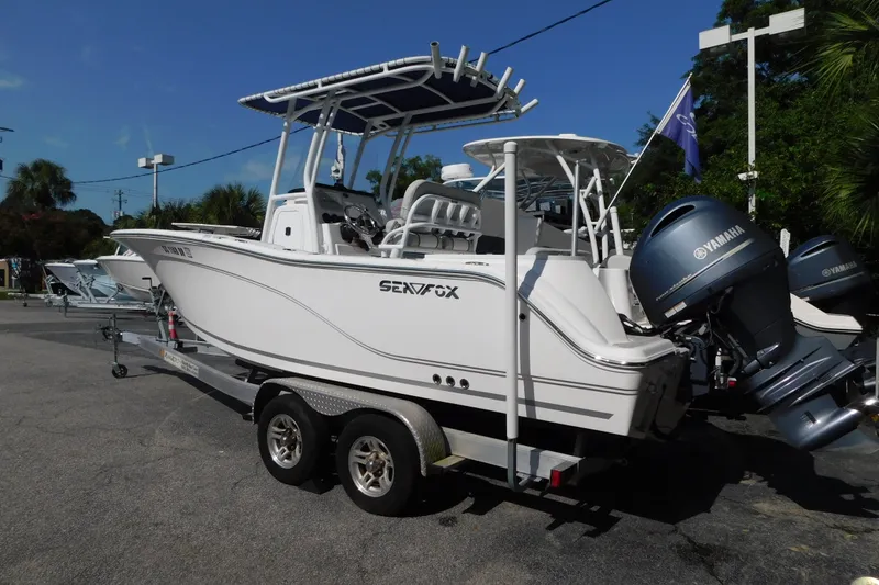 Slide: The Image of 2021 Sea Fox 228 Commander boat on trailer with Yamaha engines, parked outdoors. - 1
