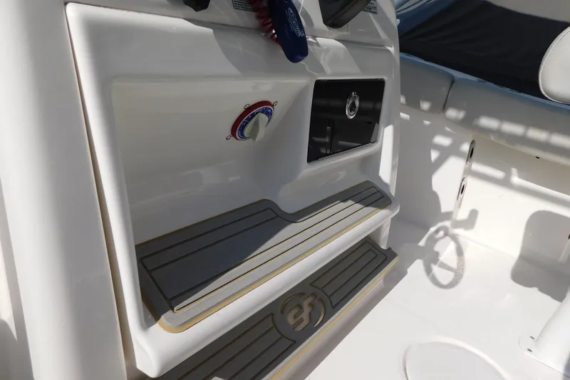 Slide: The Image of Interior view of 2021 Sea Fox 228 Commander boat, featuring storage and control panel. - 13