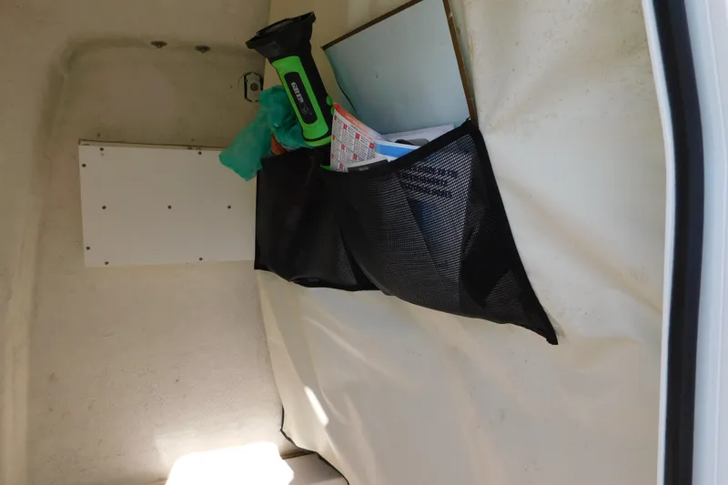 Slide: The Image of Interior storage of 2021 Sea Fox 228 Commander boat with mesh pocket and flashlight. - 16