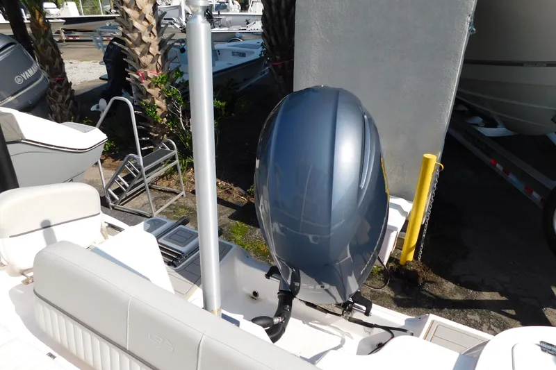 Slide: The Image of 2021 Sea Fox 228 Commander boat with Yamaha outboard motor, docked near palm trees. - 12