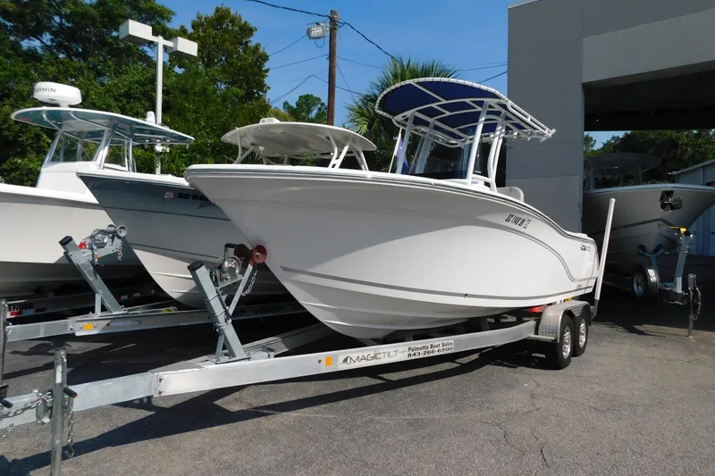 Slide: The Image of 2021 Sea Fox 228 Commander boat on trailer, parked outdoors. - 2