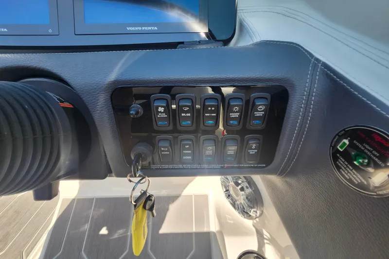 Slide: The Image of Control panel of a 2022 Regal LS6 boat with labeled switches and key ignition. - 18