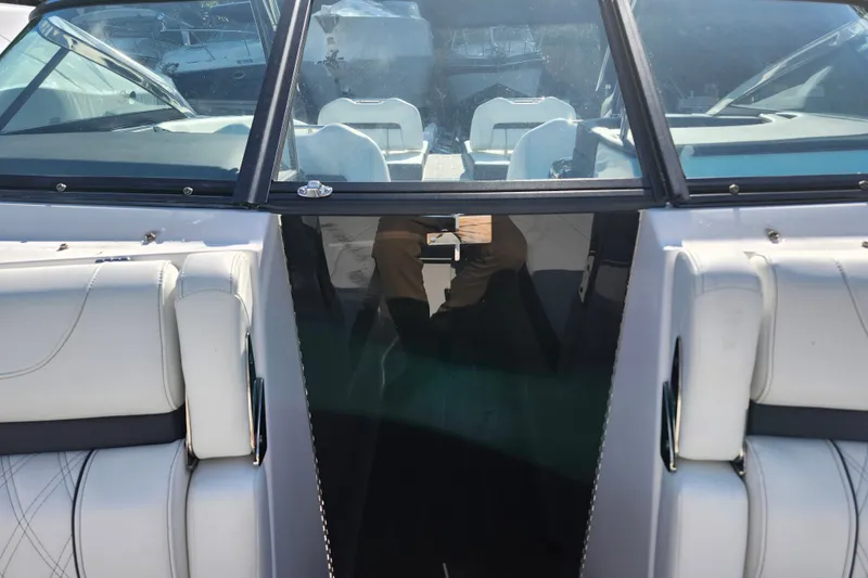 Slide: The Image of 2022 Regal LS6 boat interior with white seating and glass partition. - 24