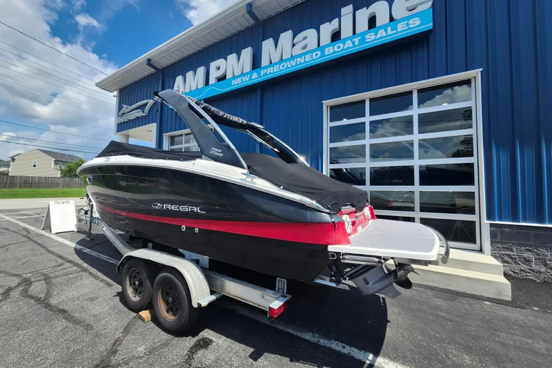 Slide: The Image of 2022 Regal LS6 boat on trailer at AM PM Marine dealership. - 2