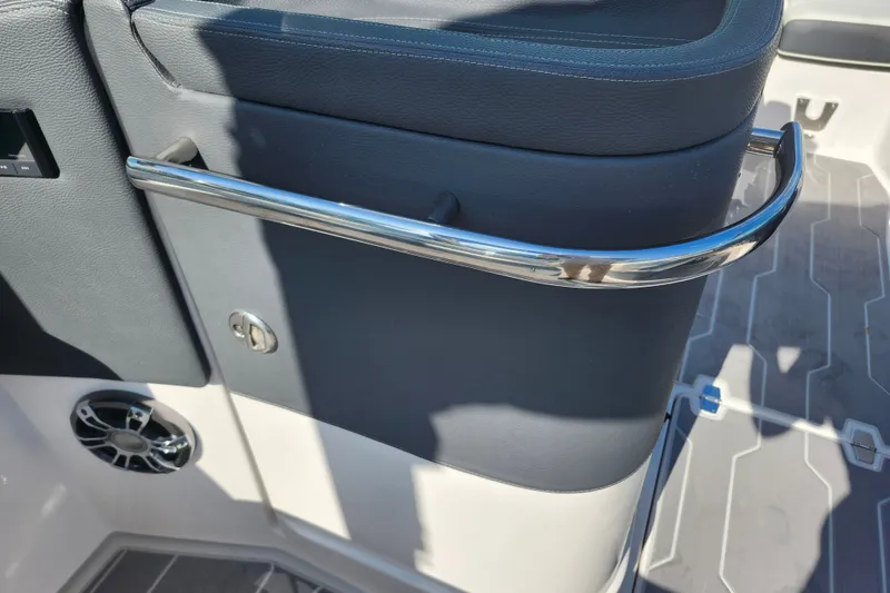 Slide: The Image of Interior detail of 2022 Regal LS6 boat, featuring sleek metal railing and speaker. - 14