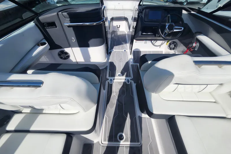 Slide: The Image of 2022 Regal LS6 boat interior with sleek white seating and modern dashboard design. - 12